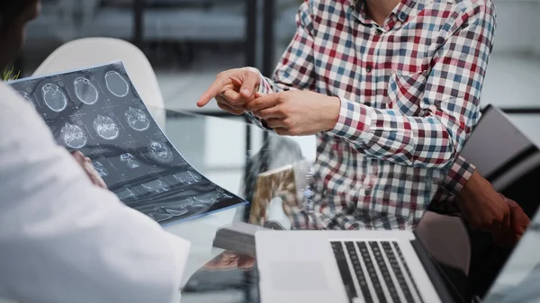 stock image patient at a reception at the doctor looking an x-ray