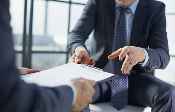 businessman is passing signed agreement to client after successful negotiation