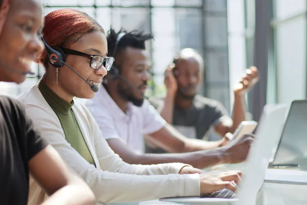 Stock image Call Center Operator With Colleagues At Workplace