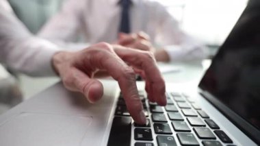 Ofiste mobil dizüstü bilgisayar üzerinde çalışan iki genç iş arkadaşı closeup görünümü