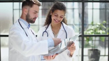 male doctor and female doctors with x-ray results. Professional consulting. Patient test results. Young professionals. group of clinicians.