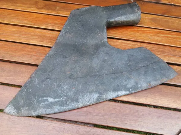 old carpenter's axe, wooden background 