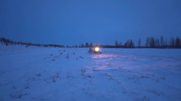 Snowmobile Glides Freezing Snowy Field Electric Blue Sky Dusk Creating — Stock Video