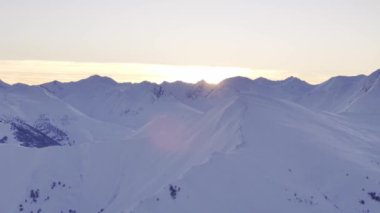 Karla kaplı görkemli Kazbegi tepelerinin nefes kesen manzarası güzel bir şekilde aydınlanıyor.