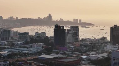 Pattaya, Tayland 'da gün batımında şehir manzarası ve kıyı şeridini gösteren hava görüntüleri..