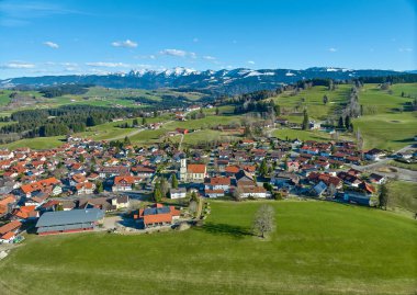 Allgaeu Alpleri, Bavyera, Almanya 'da kar kaplı Nagelfluh dağ zinciriyle Earla baharı Oberreute köyünün hava manzarası