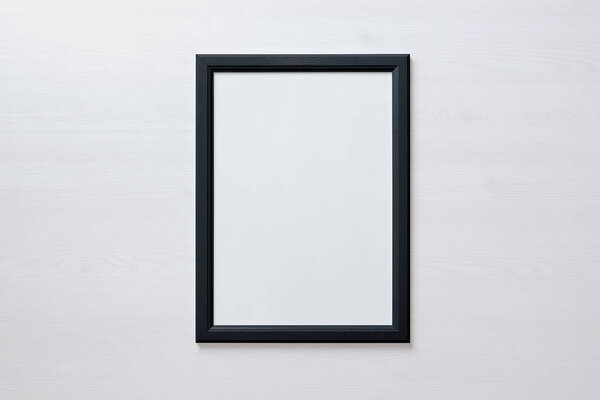 Black picture frame on white wall. Blank picture for art painting and photo hanging mockup
