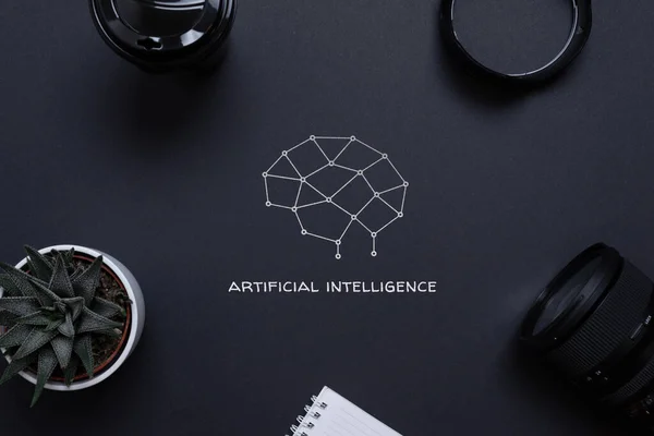 Drawing of a brain from network nodes and artificial intelligence text on a desk, surrounded by office supplies, top view, flat lay. Concept of applying AI in business