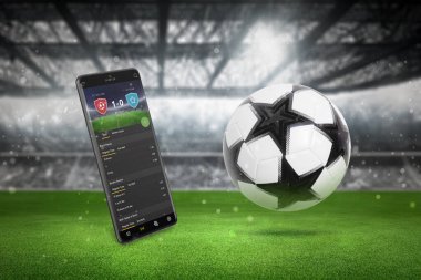 Futbol sahasında akıllı telefondan canlı skor uygulaması. Zıplayan toplu çimenler ve arka planda duruyor.