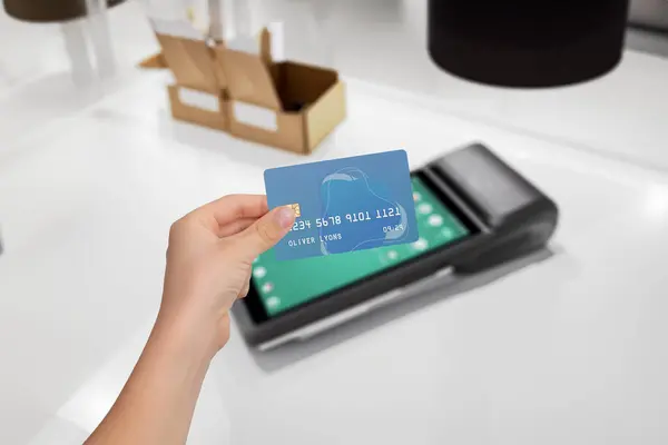 Secure card payment at sleek POS terminal. Hand holding credit card for transaction. Safe, convenient payment process