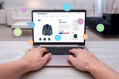 Hands typing on laptop, shopping online for men's blazer with levitating shopping icons. Modern concept of digital shopping convenience clipart