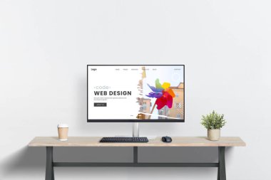 Masasında bilgisayar, bitki ve kahve fincanı olan temiz web tasarımı çalışma alanı. Web tasarımı stüdyo sunumu için minimalist sahne ideal