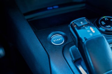 Close up of a cars start engine button and central console with gear shift, illustrating modern vehicle interior, smart controls, and push-button ignition technology clipart