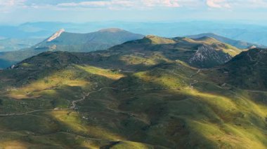Dağ sırtlarının, vadilerin ve uzak ufukların havadan çekilmiş görüntüleri parlak bir yaz öğleden sonrasında çekildi.