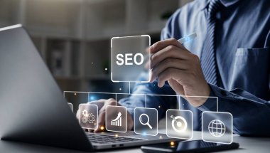 Hand of businessman holding a pen pointing to SEO Search Engine Optimization on laptop screen. Digital marketing process, Strategy,  Business Technology concept.