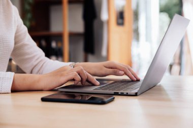 Businesswoman working on a laptop computer in home office, Work from home.