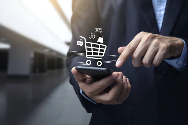 Young Man Using Smartphone Shopping Cart Icon Online Shopping Commerce — Φωτογραφία Αρχείου