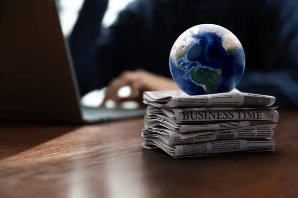 The globe puts on pile of newspaper in front of businessman, world economic and financial stock trading with news concept. Elements of this image furnished by NASA