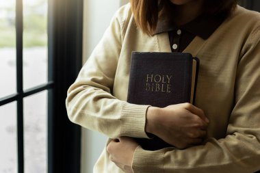 İncil 'le Tanrı' ya dua eden genç bir kadın, Tanrı inancı kavramı..