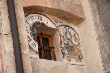 VILLANDRO, ITALY - SEPTEMBER 04, 2020: the recently restored historical paintings on the external walls long the way of the center of the little mountain town clipart