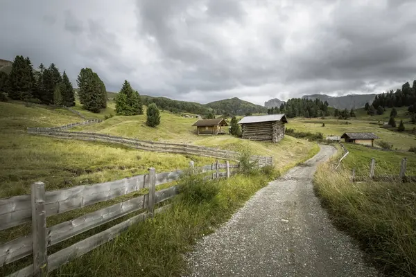 Dolomitler 'de bir dağ otlağının üzerinde harika manzaralı küçük bir ev.
