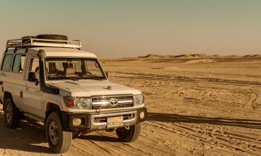 Tourists Safari Touring Jeep In Desert Landscape