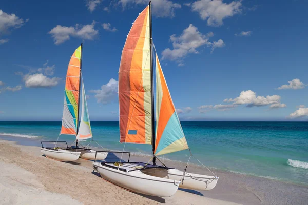 Colorful sailing catamaran on the beach of the Varadero -  Cuba.Turquoise blue Atlantic water and blue sky with white clouds.