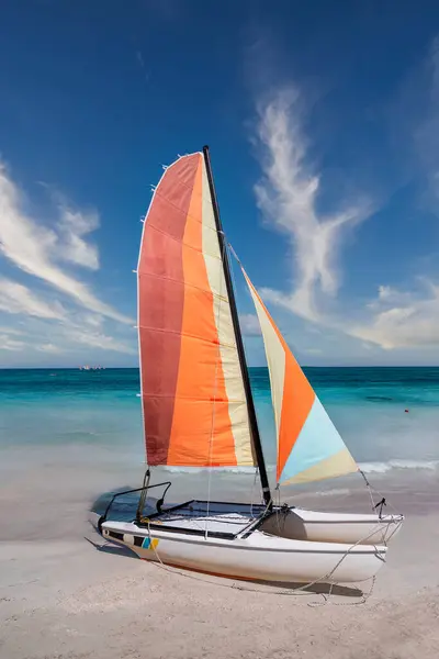 Colorful sailing catamaran on the beach of the Varadero -  Cuba.Turquoise blue Atlantic water and blue sky with white clouds.