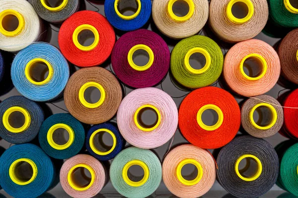 stock image set of multi-colored spools of thread for sewing close-up