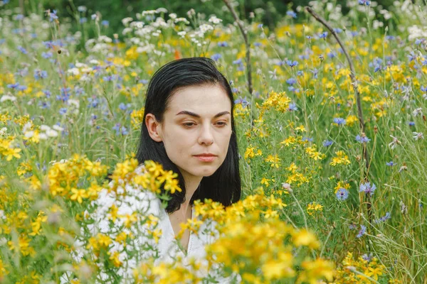 stock image Beautiful girl among the summer field with wildflowers close-up