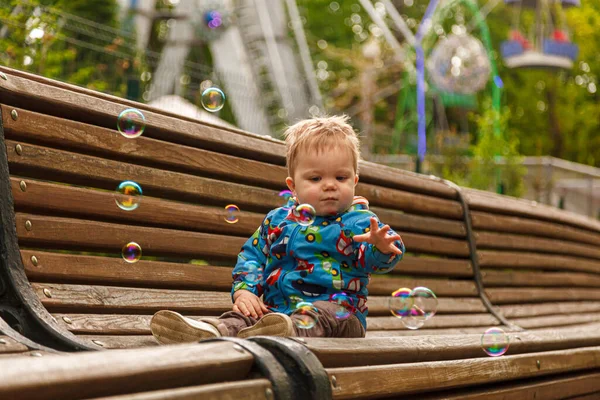 Portrait Little Boy Park Bench Catching Soap Bubbles Close — Stockfoto