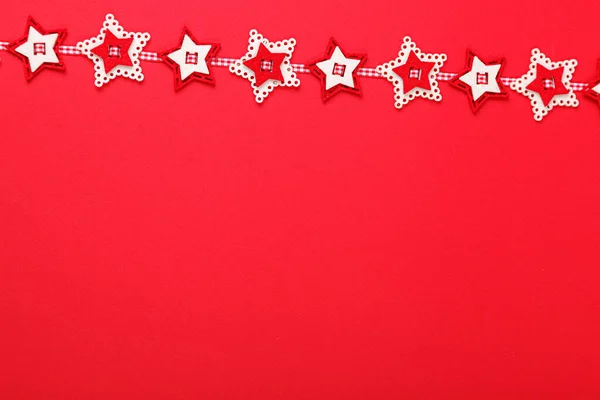 stock image Christmas garland on a red background close-up