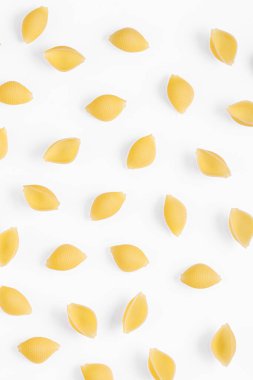 Pasta products in the form of a shell, texture, on a white background close-up