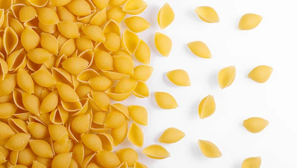 Pasta products in the form of a shell, texture, on a white background close-up
