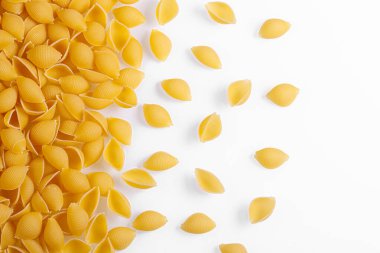 Pasta products in the form of a shell, texture, on a white background close-up