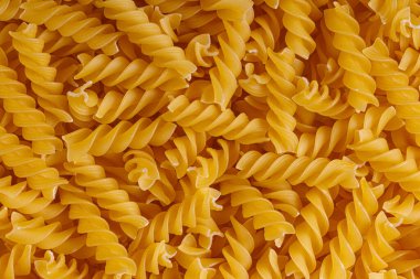 Pasta products in the form of a spiral, texture, close-up