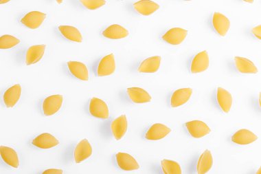Pasta products in the form of a shell, texture, on a white background close-up