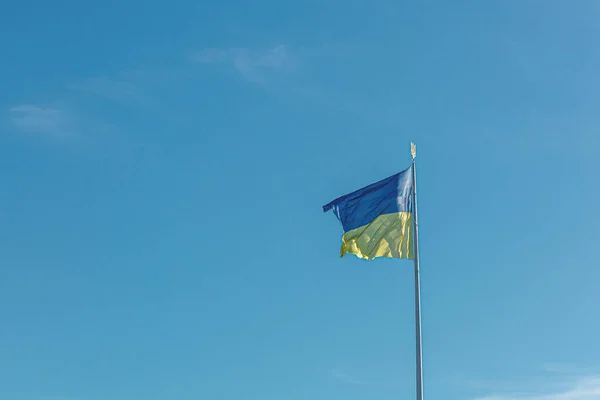 stock image Ukrainian flag against the blue sky close-up