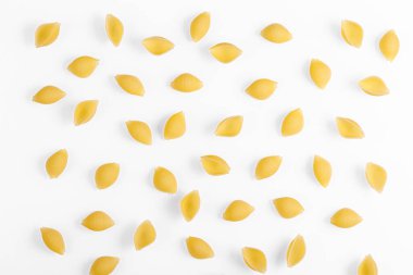 Pasta products in the form of a shell, texture, on a white background close-up