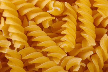 Pasta products in the form of a spiral, texture, close-up