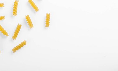 Pasta products in the form of a spiral, texture, on a white background close-up