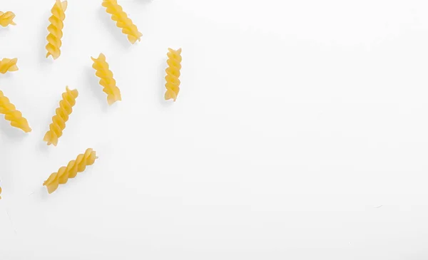 stock image Pasta products in the form of a spiral, texture, on a white background close-up