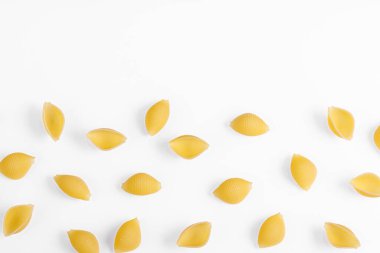 Pasta products in the form of a shell, texture, on a white background close-up
