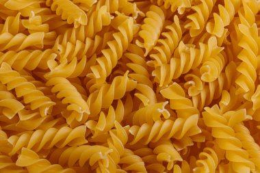 Pasta products in the form of a spiral, texture, close-up