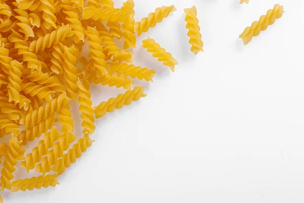 stock image Pasta products in the form of a spiral, texture, on a white background close-up