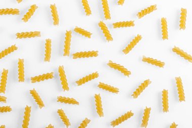 Pasta products in the form of a spiral, texture, on a white background close-up