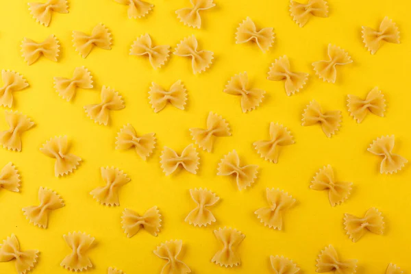 stock image Different types and shapes of dry italian pasta on a yellow background close-up