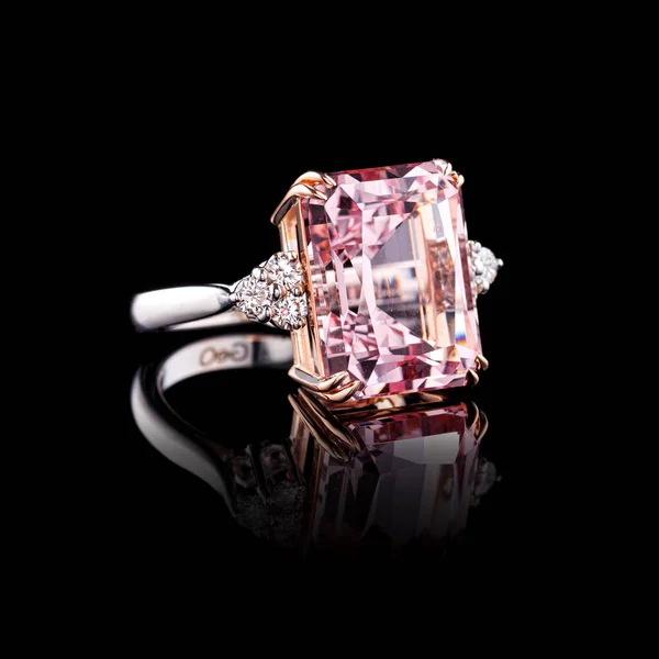 beautiful white gold ring with diamonds and morganite on a black background close-up