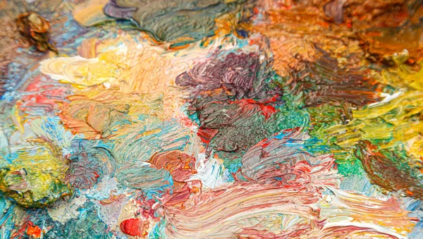 painting palette with different colors of paint close-up