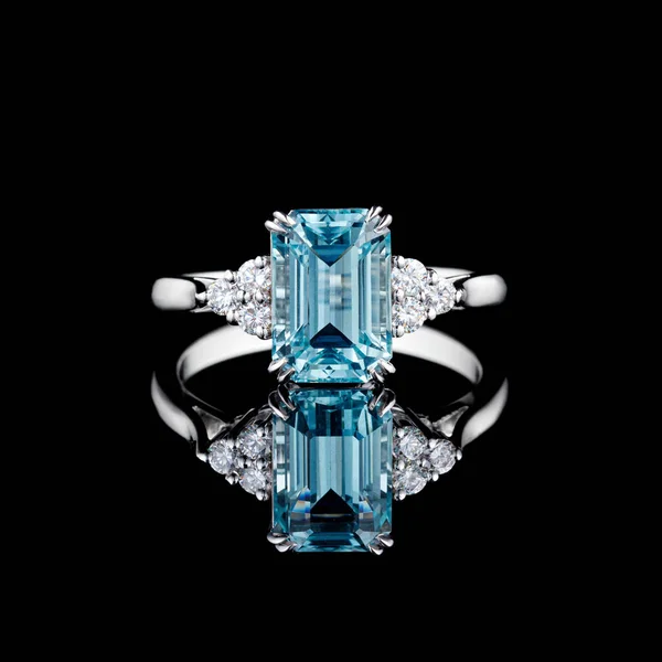 beautiful white gold ring with diamonds and aquamarine on a black background close-up